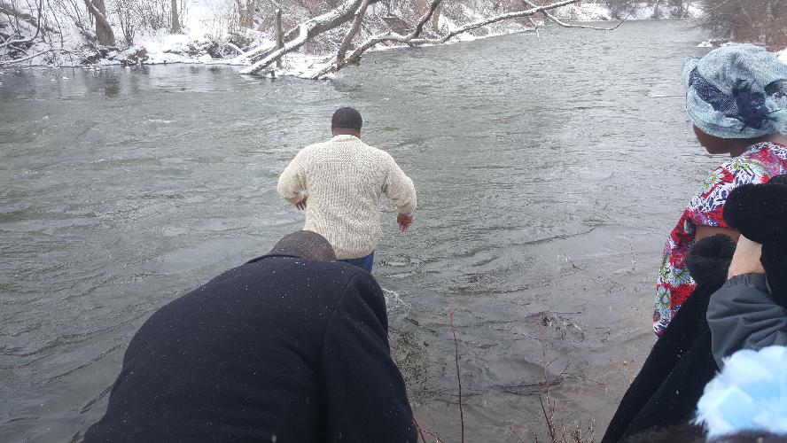 Pastor getting into the icy cold water